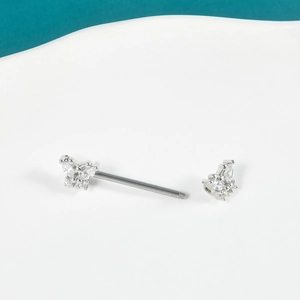 Close-up of butterfly nipple ring piercing with silver stainless steel and zircon inlay