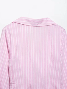 Close-up detail of the pink and white striped V-neck dress collar and fabric texture