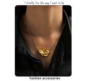 Detail of 18k gold plated geometric lava pendant on a sleek snake chain necklace