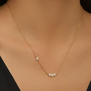 Detail of 925 sterling silver gold necklace with delicate floral zircon clusters on skin