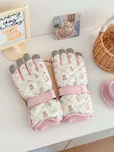 Detail of floral teddy bear ski gloves with adjustable wrist strap and anti-slip fingertips