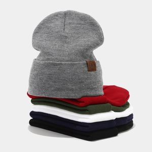 Unisex knit beanie hats in multiple colors with a compass patch for outdoor hiking