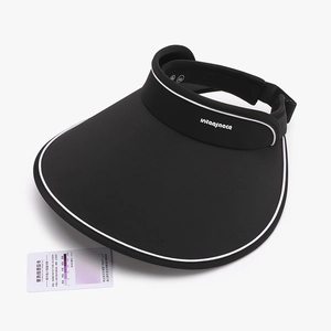 Women's UV protection black sun visor with wide brim and white contrast trim and test card