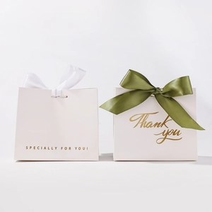 Elegant gold foil wedding favor boxes with green ribbon and Thank You typography