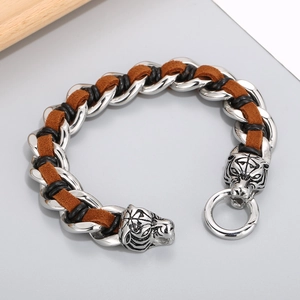 Close-up of titanium steel tiger head bracelet with brown leather braided details