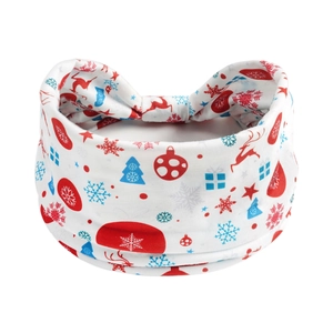 Detail of Christmas headband with red reindeer, snowflakes and trees on soft white fabric