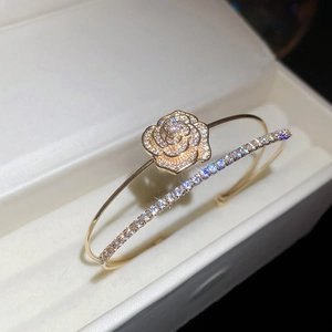 Detailed macro of golden double-layer zircon flower ring in a velvet jewelry box