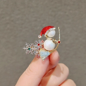 Enamel snowman brooch with pearl body and gold skis decorated with colorful rhinestones