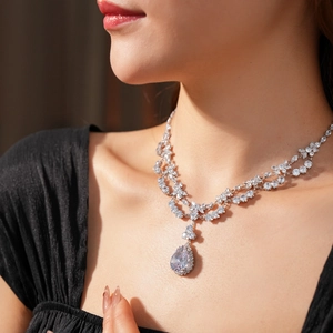 Detailed view of luxury zircon waterdrop pendant on double-layer silver chain necklace