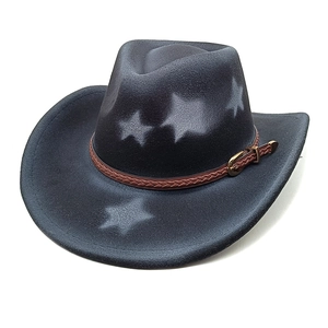 Detail of black felt western cowboy hat with white star pattern and brown braided band