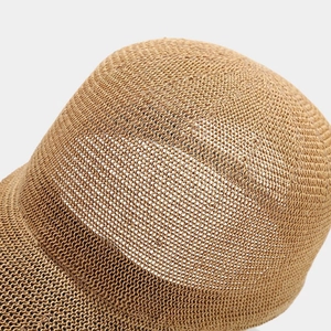 Close-up of the detailed woven straw texture on the top of this khaki baseball cap