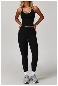 Detailed shot of black halter neck sports bra and high-waist yoga pants set