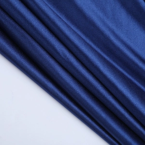 Detailed macro shot of silky dark blue satin fabric with a metallic lustrous texture
