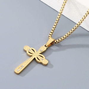 Close-up of golden box chain necklace with a rhinestone infinity cross pendant