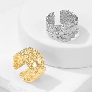 Adjustable open rings in gold and silver with irregular hammered texture on metal finish
