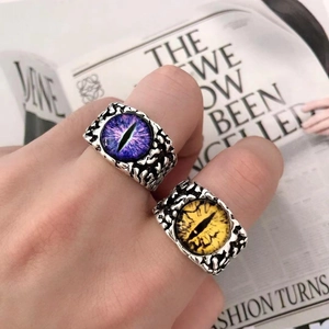 Close-up of vintage punk rings featuring purple and yellow devil's eye designs