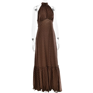 Macro detail of brown polka dot satin fabric with halter neck and ruffled hemline