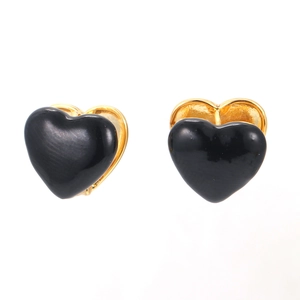 Minimalist heart stud earrings with black enamel and gold metal base on white background