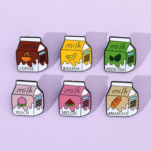 Detailed view of six colorful enamel milk box pins with coffee and fruit patterns
