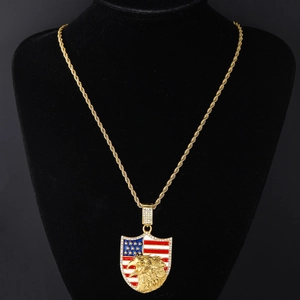 Detail of hip hop shield pendant with eagle head and US flag enamel on gold chain