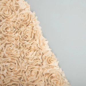 Detailed macro view of beige 3D rose lace fabric with tiered mesh tulle petals