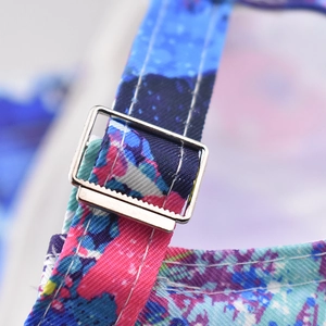 Detailed macro shot of adjustable metal buckle on colorful graffiti cotton baseball cap