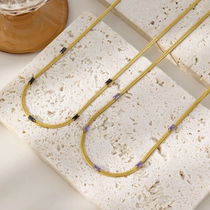 Detail of 18K gold-plated snake chains with purple and black rectangular zircon stones