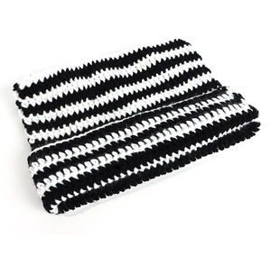 Detailed close-up showing the black and white striped knit texture of the wool cat ear hat