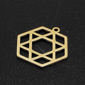 Detail of gold hexagon geometric pendant with S925 hallmark on dark textured surface