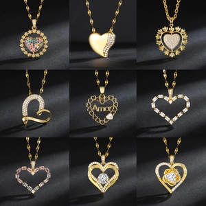 Set of nine gold-plated heart necklaces with colorful zircon stones on black background