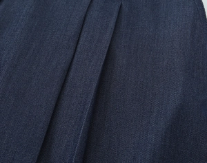 Vue macro détaillée de la texture du tissu denim sergé bleu foncé et motifs de tissage