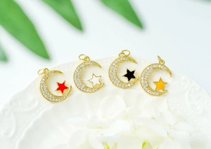 Detailed close-up of 18K gold plated moon and star pendants with colorful zircon inlay