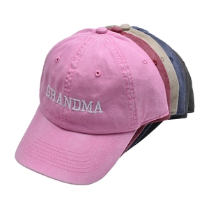 Detailed pile of embroidered GRANDMA cotton baseball caps in multiple vibrant colors