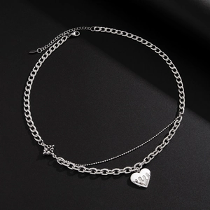 Detail of silver double-layered heart necklace with cuban and bead chain style