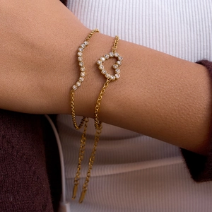 Ensemble de bracelets coeur et vague en zircon plaqué or 18K porté sur un poignet