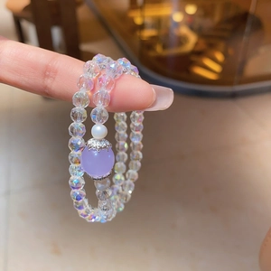 Detail of amethyst purple wrap bracelet with faceted crystal beads and faux pearls