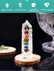 Macro detail of wire-wrapped natural crystal tower with chakra stones on wood base