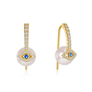 Detail of 925 silver gold evil eye earrings with white pearl and blue zircon