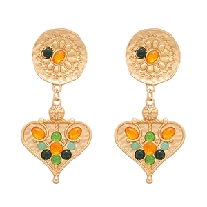 Vintage gold heart earrings with floral motifs and multicolor resin stones on white background