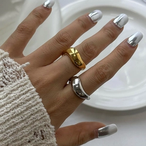 Minimalist irregular fluid style rings in gold and silver finish on hand