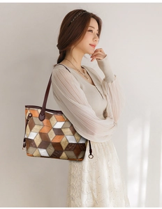 Detail of 3D geometric patchwork tote bag with orange and brown PU leather textures