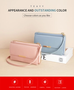 Detail view of pink and blue matte leather crossbody phone wallets with gold hardware