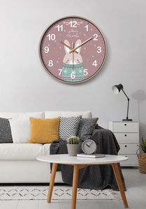 Detail of pink cartoon rabbit wall clock with Merry Christmas greeting and golden frame