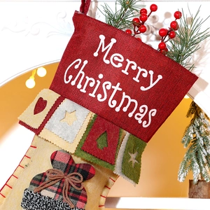 Large Christmas stocking with Santa reindeer pattern hanging by a warm festive fireplace