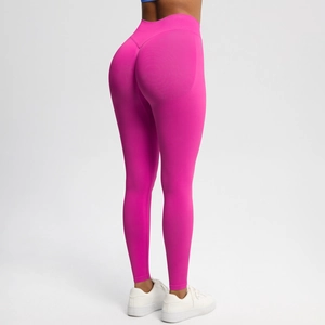 Rear view of seamless high-waist yoga pants in magenta with peach butt lifting detail