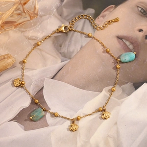 Detail of 18K gold-plated anklet with fish charms and green amazonite stones