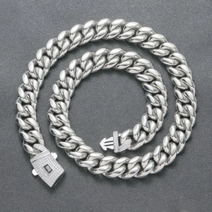 Close-up of thick stainless steel Cuban link chain with zircon micro-pave square clasp