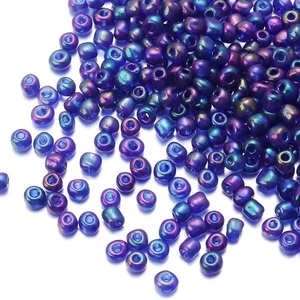 Macro shot of 2mm iridescent seed beads with purple-green metallic luster for jewelry