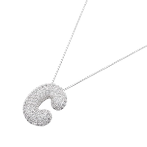Macro detail of a 3D bubble letter C pendant encrusted with sparkling cubic zirconia