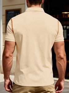 Close-up back view of men's beige slim fit polo shirt with ribbed cuffs and contrast stitching